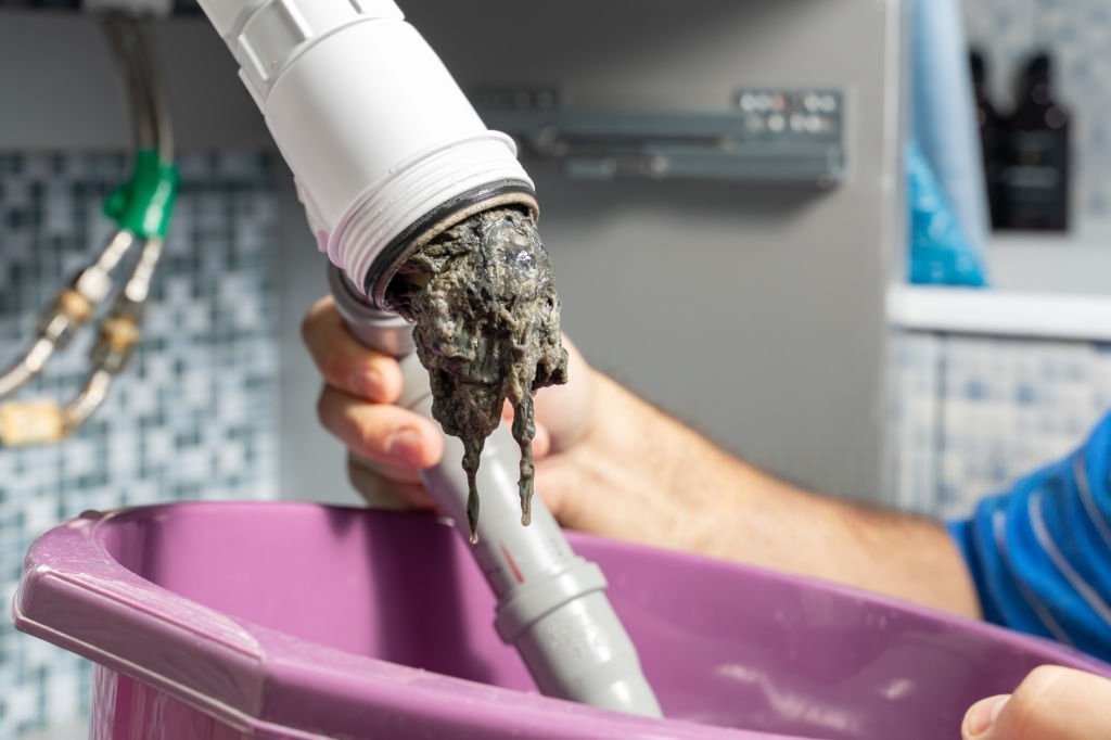 General plumbing services in Payson showing a clogged pipe during a plumbing repair job